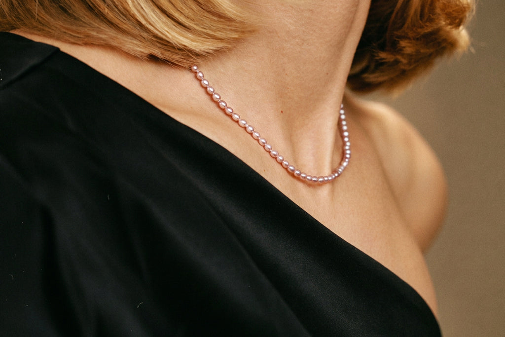 Tiny Lavender Pearl Necklace in warm light