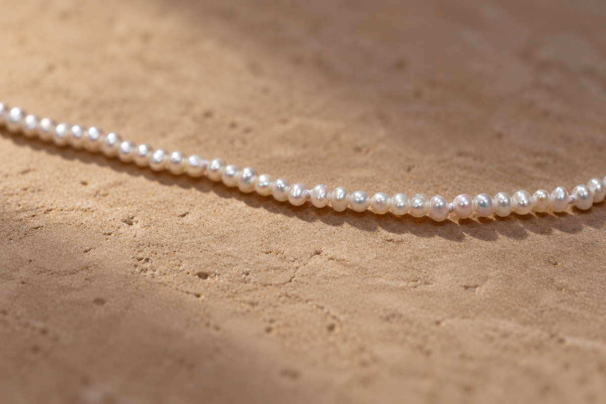 Super Small White Pearl Necklace on stone