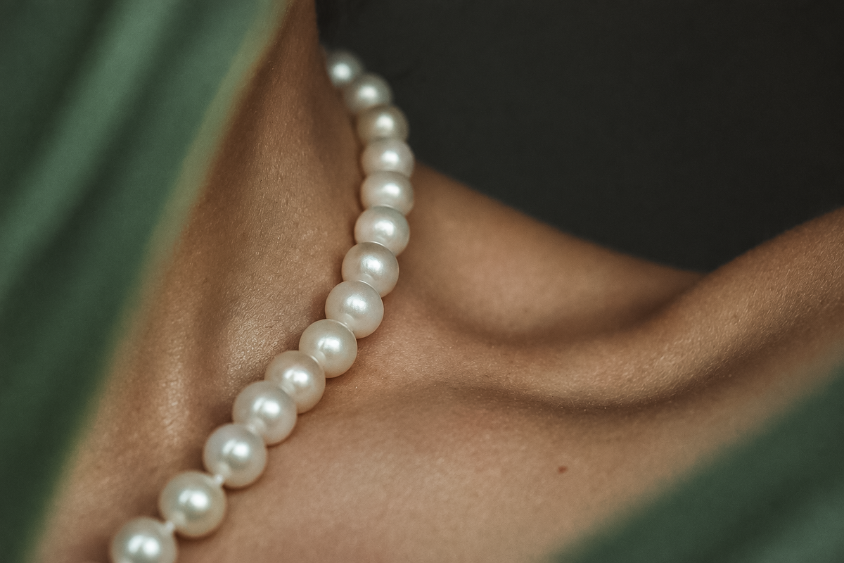 White Pearl Necklace, worn on the neck and shoulder